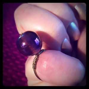 Wire wrapped ring with large iridescent glass bead